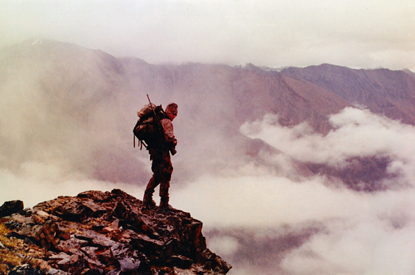 Young Guide Billy Molls on a mountain top in Alaska